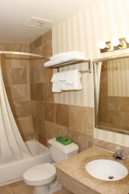 a bathroom with a toilet and a sink and a tub at Super 8 by Wyndham Allentown Kutztown Area in Kutztown