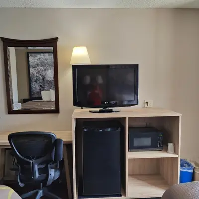 a room with a television and a desk with a chair at Super 8 by Wyndham Allentown Kutztown Area in Kutztown