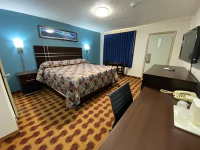 a hotel room with a bed and a desk at Lodge Inn Wrightstown - Fort Dix in Wrightstown