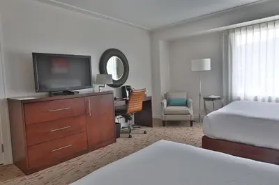 a hotel room with a bed and a flat screen tv at Wind Creek Bethlehem Casino & Resort in Bethlehem
