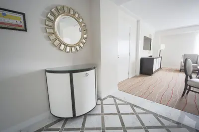 a living room with a round mirror and a table at Wind Creek Bethlehem Casino & Resort in Bethlehem