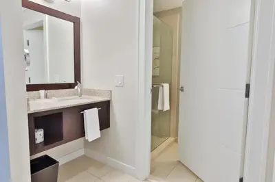 a bathroom with a sink and a mirror and a shower at Wind Creek Bethlehem Casino & Resort in Bethlehem
