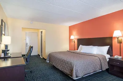 a hotel room with a bed and a desk at Rodeway Inn Meadowlands in Secaucus