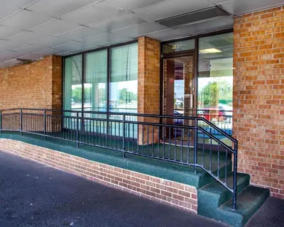 a building with a balcony in front of a building at Rodeway Inn Meadowlands in Secaucus