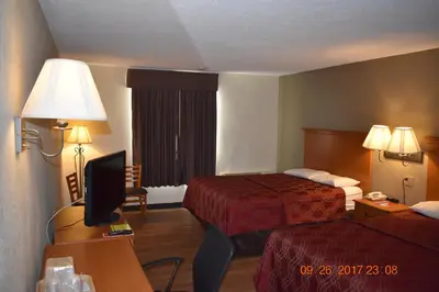 a hotel room with two beds and a television at MHO Hotel Bordentown in Bordentown