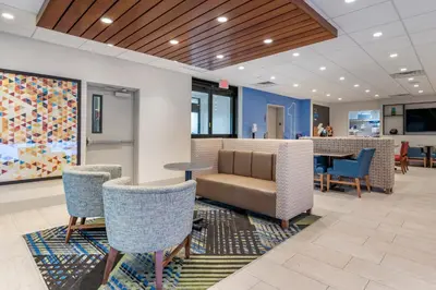 a lobby with a waiting area with chairs and a table at Holiday Inn Express Jonestown Ft Indiantown Gap by IHG in Jonestown