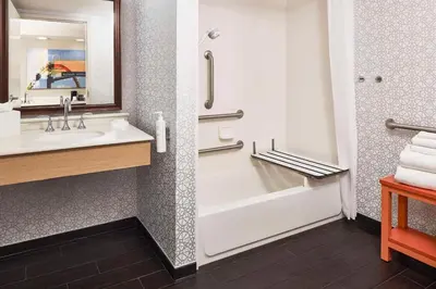 a bathroom with a tub and a sink and a shower at Hampton Inn & Suites Hershey Near the Park in Hummelstown