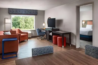 a hotel room with a bed and a desk with a television at Hampton Inn & Suites Hershey Near the Park in Hummelstown