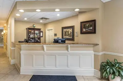 a bar in a hotel lobby with a reception counter at Traditions Hotel & Spa Johnson City - Binghamton, an Ascend Collection Hotel in Johnson City