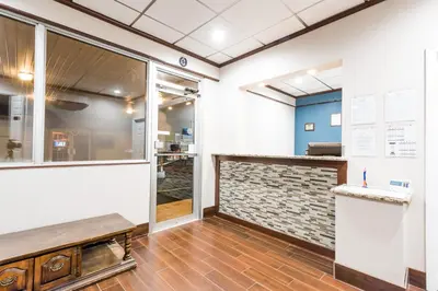 a restaurant lobby with a counter and a window at Red Carpet Inn Lancaster in Lancaster