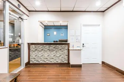 a room with a counter and a door at Red Carpet Inn Lancaster in Lancaster
