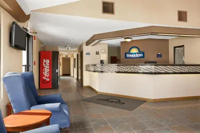 a hotel lobby with a cocacola counter and chairs at Days Inn by Wyndham Middletown in New Hampton