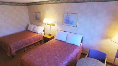 a room with two beds in a hotel room at Value Inn Harrisburg-York in Valley Green