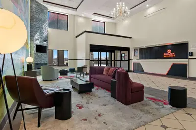 a living room with a couch and chairs at Ramada by Wyndham Harrisburg/Hershey Area in Harrisburg