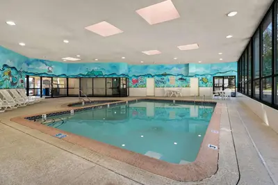 a swimming pool with a mural on the wall at Ramada by Wyndham Harrisburg/Hershey Area in Harrisburg