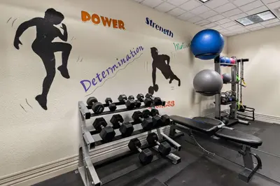 a gym with a wall with a mural of a diver at Ramada by Wyndham Harrisburg/Hershey Area in Harrisburg