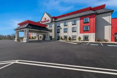 a hotel with a parking lot in front of it at Ramada by Wyndham Harrisburg/Hershey Area in Harrisburg