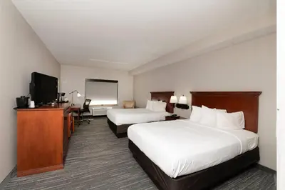 a hotel room with two beds and a flat screen tv at Country Inn & Suites by Radisson, Harrisburg - Hershey West, PA in Harrisburg