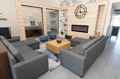 a living room with two couches and a tv at Country Inn & Suites by Radisson, Harrisburg - Hershey West, PA in Harrisburg