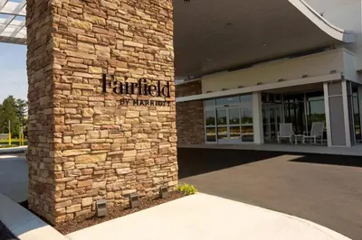a brick building with a sign on the side of it at Fairfield Inn & Suites by Marriott Philadelphia Broomall/Newtown Square in Broomall