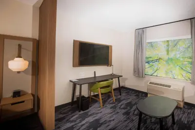 a hotel room with a desk and a television at Fairfield Inn & Suites by Marriott Philadelphia Broomall/Newtown Square in Broomall