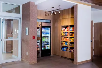 a room with a refrigerator and shelves with drinks at Fairfield Inn & Suites by Marriott Philadelphia Broomall/Newtown Square in Broomall