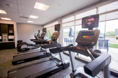a gym with several treadmills and a tv on a treadmill at Fairfield Inn & Suites by Marriott Philadelphia Broomall/Newtown Square in Broomall