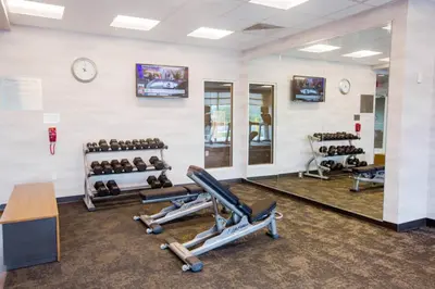 a gym with several exercise machines and a mirror at Fairfield Inn & Suites by Marriott Philadelphia Broomall/Newtown Square in Broomall