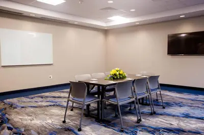 a conference room with a table and chairs and a whiteboard at Fairfield Inn & Suites by Marriott Philadelphia Broomall/Newtown Square in Broomall