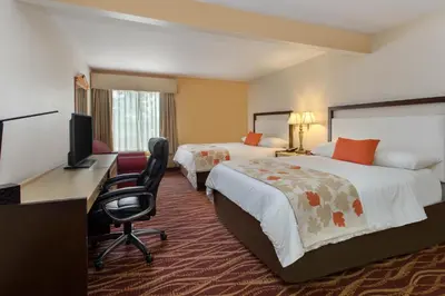 a hotel room with two beds and a desk with a computer at Hawthorn Suites by Wyndham Allentown-Fogelsville in Fogelsville