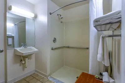 a white bathroom with a sink and a shower at Hawthorn Suites by Wyndham Allentown-Fogelsville in Fogelsville