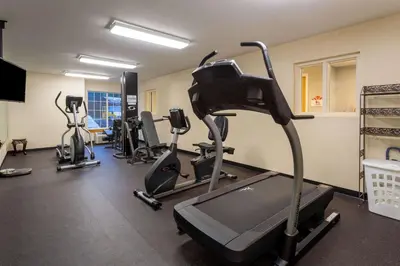 a gym with several treadmills and exercise bikes at Hawthorn Suites by Wyndham Allentown-Fogelsville in Fogelsville