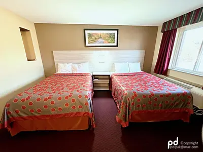 a hotel room with two beds and a window at Travel Inn & Suites Flemington in Flemington