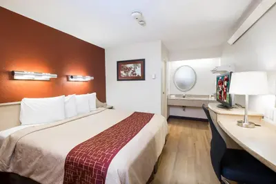 a hotel room with a bed and a desk at Red Roof Inn Harrisburg - Hershey in Harrisburg
