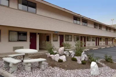 a building with a table and benches in front of it at Red Roof Inn Harrisburg - Hershey in Harrisburg