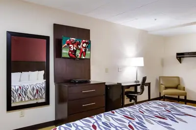 a hotel room with a bedroom with a bed and a desk at Red Roof Inn York Downtown in York