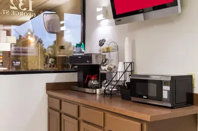 a kitchen with a counter with a microwave and a tv at Red Roof Inn York Downtown in York