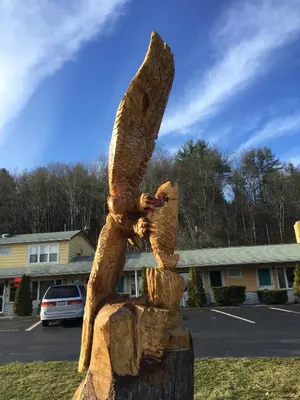 a statue of an eagle sitting on a tree stump at FairBridge Inn Express Milford in Milford