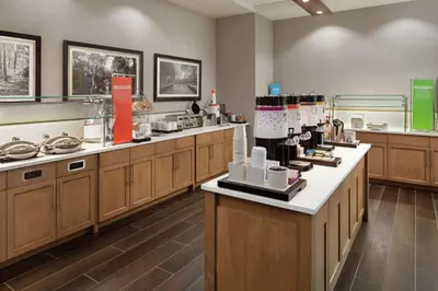 a kitchen with wooden cabinets and aasteryasteryasteryasteryasteryasteryasteryasteryastery at Hampton Inn & Suites Teaneck/Glenpointe in Teaneck