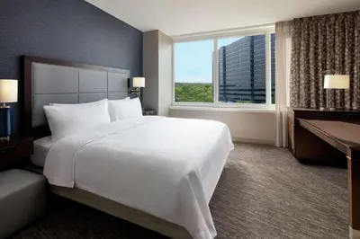 a large white bed in a hotel room with a window at Hampton Inn & Suites Teaneck/Glenpointe in Teaneck