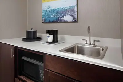 a kitchen counter with a sink and a microwave at Hampton Inn & Suites Teaneck/Glenpointe in Teaneck