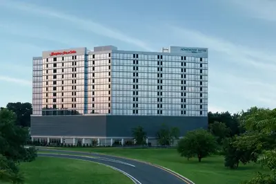 a large building with a road in front of it at Homewood Suites By Hilton Teaneck Glenpointe in Teaneck