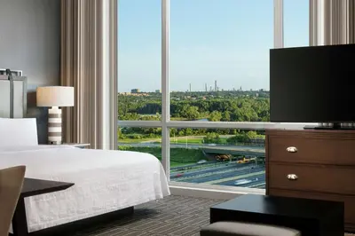 a room with a large window with a bed and a television at Homewood Suites By Hilton Teaneck Glenpointe in Teaneck