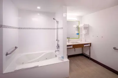 a white bathroom with a tub and a sink at Hampton Inn By Hilton Paramus in Paramus