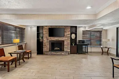 a living room with a fireplace and a tv at Motel 6 Lester - Philadelphia Airport in Lester