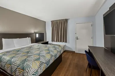 a hotel room with a bed and a desk at Motel 6 Lester - Philadelphia Airport in Lester