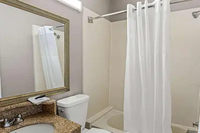 a bathroom with a toilet and a shower curtain at Motel 6 Lester - Philadelphia Airport in Lester