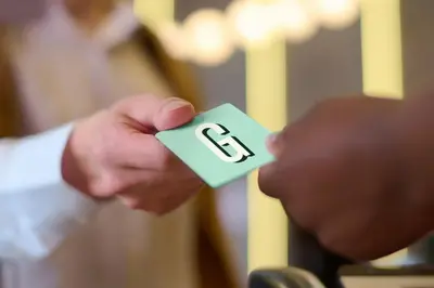 a person holding a piece of paper with the letter e on it at Garner Hotel Mahwah by IHG in Mahwah