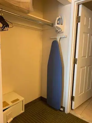a room with a blue surfboard hanging on the wall at Host Inn an All Suites Hotel in Wilkes-Barre