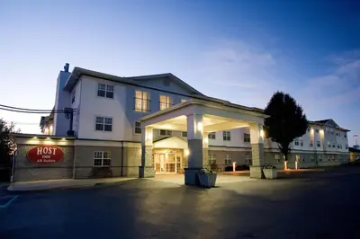 a building with a lit up front of it at Host Inn an All Suites Hotel in Wilkes-Barre